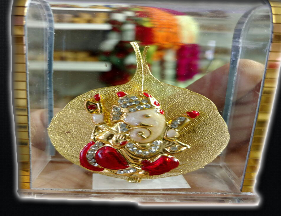 Mesmerizing Glass Covered Lord Ganesha idol with Golden leaf framework Mesmerizing Glass Covered Lord Ganesha idol with Golden leaf framework