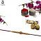 Swastika RAKHI in Gold W/ Red Beads and Diamonds + Roli & Chaval Swastika RAKHI in Gold W/ Red Beads and Diamonds + Roli & Chaval