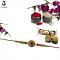 Ruby Rakhi with Intricate Diamond Arrangement + Roli & Chaval Ruby Rakhi with Intricate Diamond Arrangement + Roli & Chaval