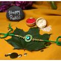 Green Gem Stone Rakhi Surrounded By Green Beads + Roli & Chaval Green Gem Stone Rakhi Surrounded By Green Beads + Roli & Chaval