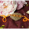 Aesthetic Rakhi with Red & Orange Beads + Roli & Chaval Aesthetic Rakhi with Red & Orange Beads + Roli & Chaval