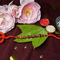 Marble Effect Red Beads Rakhi + Roli & Chaval Marble Effect Red Beads Rakhi + Roli & Chaval