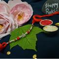 Adorable Silver laughing Buddha Rakhi W/ Cute Beads + Roli & Chaval Adorable Silver laughing Buddha Rakhi W/ Cute Beads + Roli & Chaval