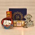 Sarp Ganesha Idol with Diya, Roasted Almonds, Chocolates & Kaju Katli Sarp Ganesha Idol with Diya, Roasted Almonds, Chocolates & Kaju Katli