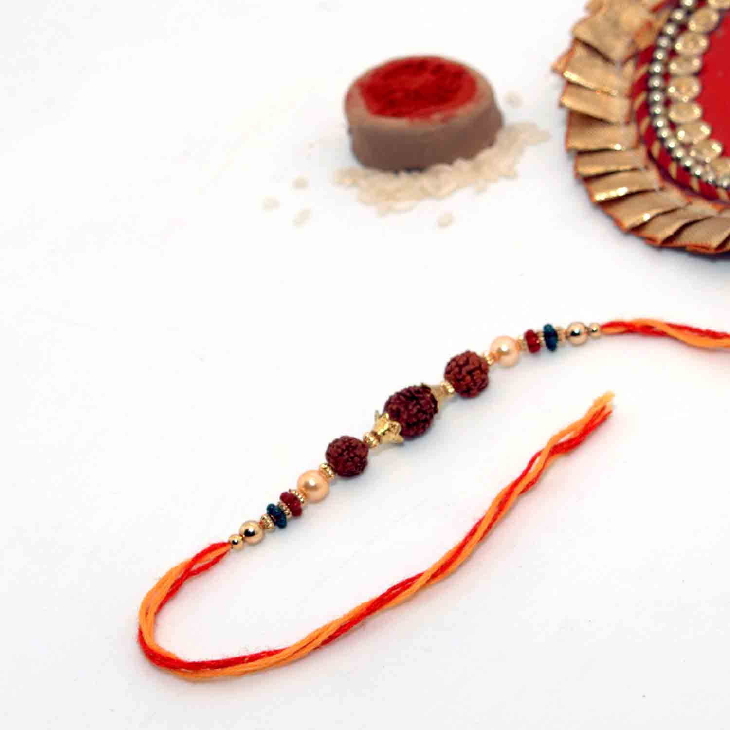3 Rudraksha Seeds Rakhi In A Multi-Toned Thread 3 Rudraksha Seeds Rakhi In A Multi-Toned Thread
