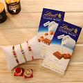 Rakhi GIft Hamper - Three Rakhis w/ Two Bars of Lindt Classic Chocolate Rakhi GIft Hamper - Three Rakhis w/ Two Bars of Lindt Classic Chocolate
